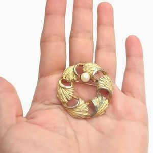 BSK gold tone wreath brooch with what I believe is a real pearl.